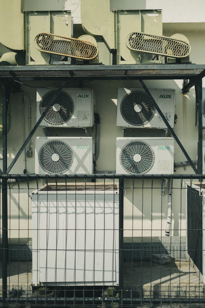 Vertical shot of multiple air conditioner units outside a building